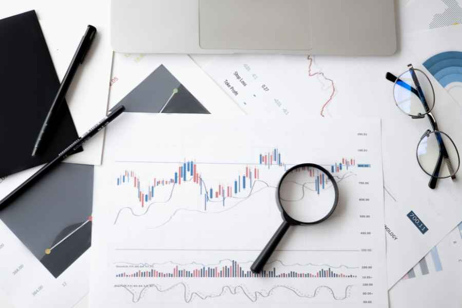 a magnifying glass on paper with graphs