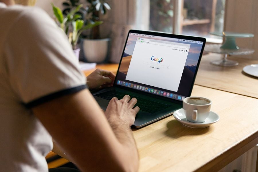 man typing on laptop