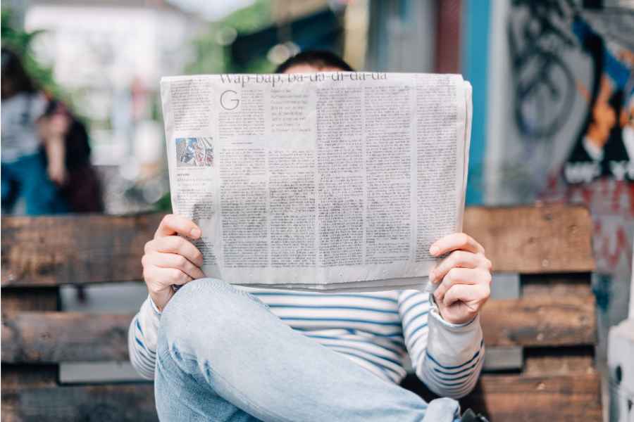 person behind newspaper