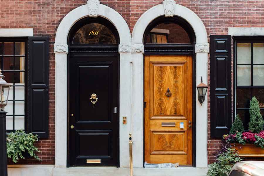 two doors side by side in a brick wall